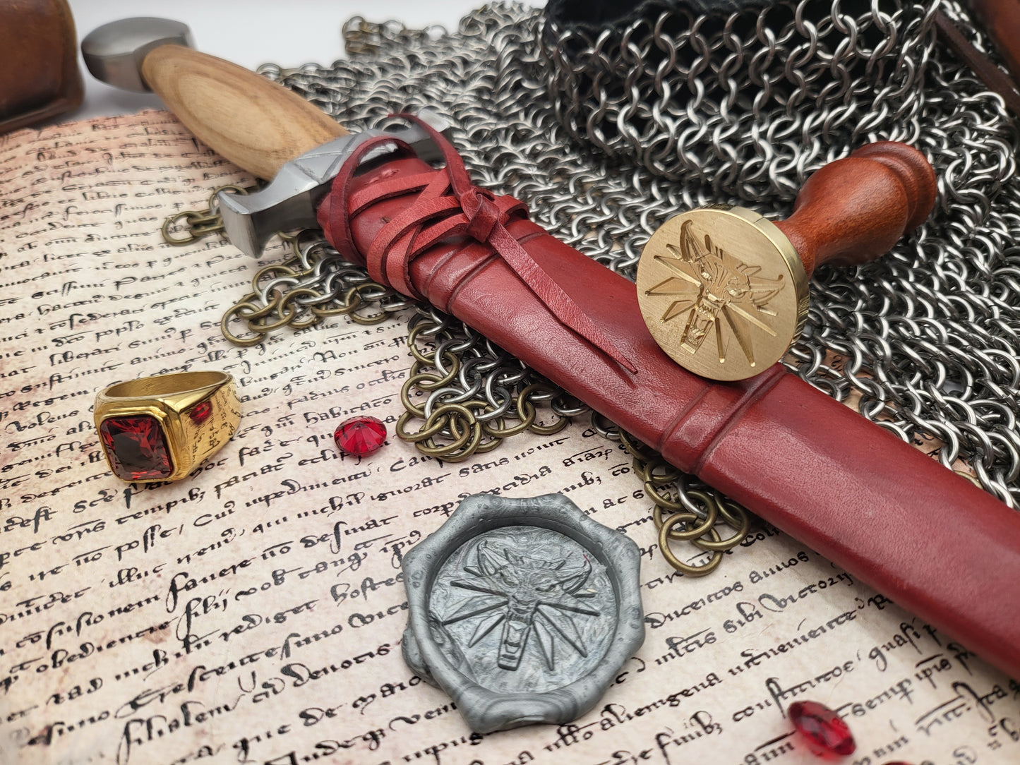 Witcher Wolf medallion brass wax seal stamp displayed with red sealing wax and chainmail.