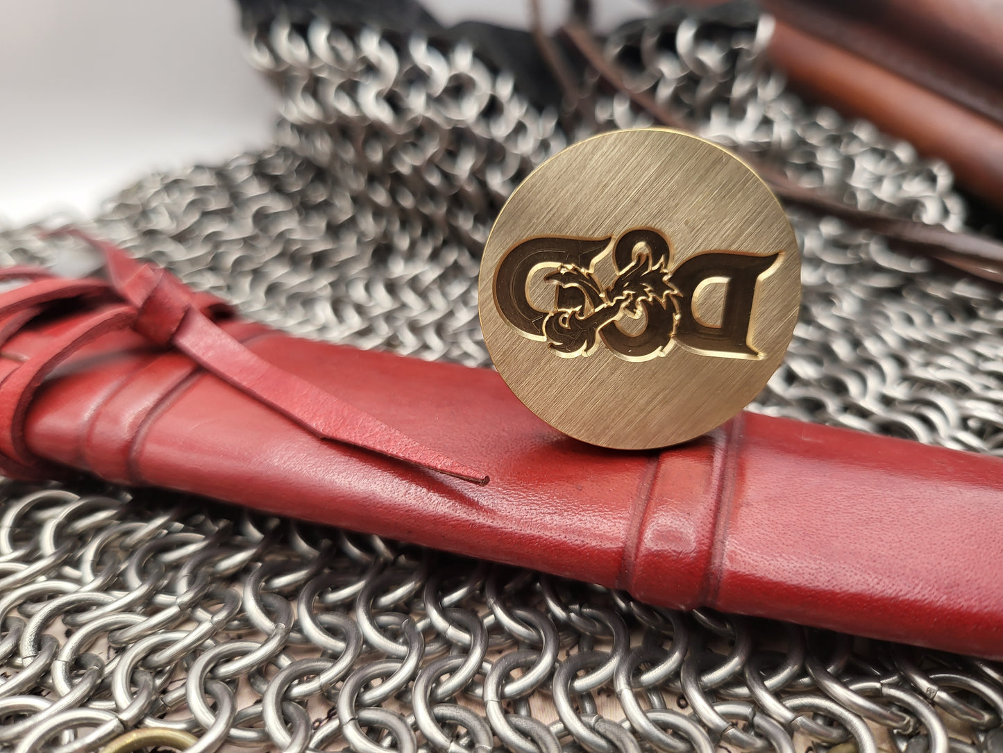 Close-up of D&D wax seal impression featuring the dragon ampersand symbol.