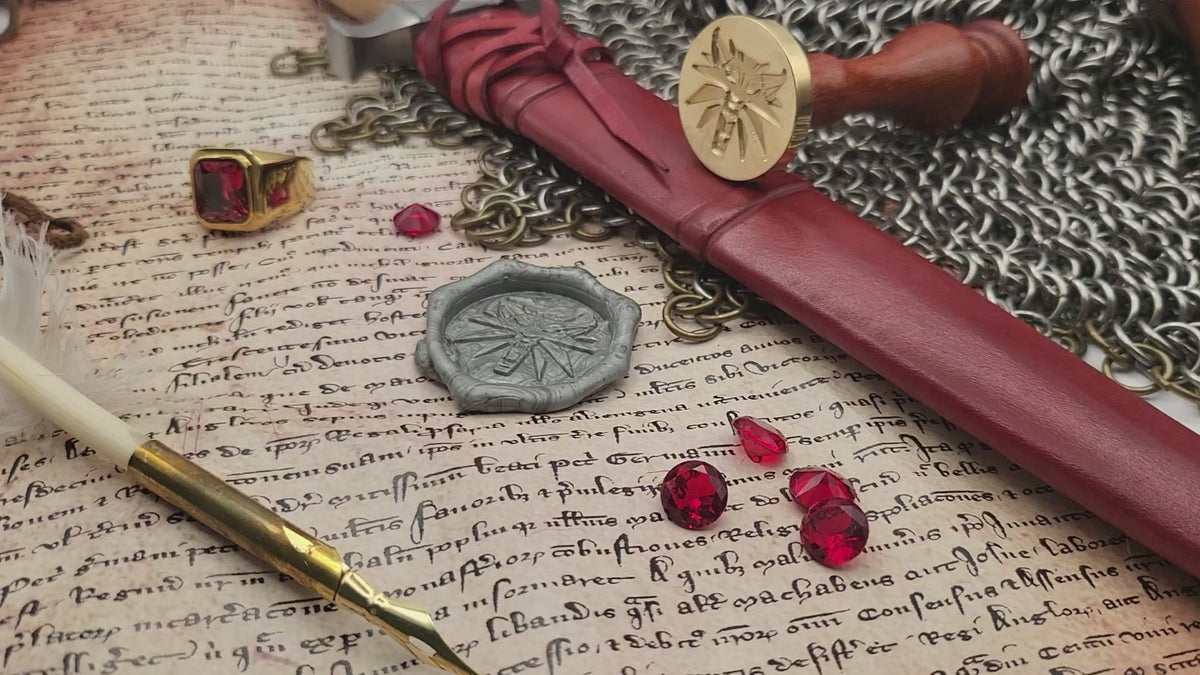 Witcher Wolf brass wax seal stamp displayed on an open book with chainmail.